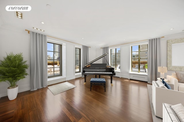 sitting room featuring baseboards, wood finished floors, and visible vents
