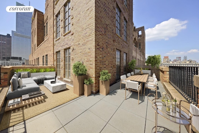 view of patio with a city view, an outdoor hangout area, and outdoor dining space