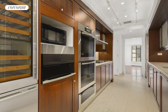 kitchen with visible vents, appliances with stainless steel finishes, light countertops, beverage cooler, and a warming drawer