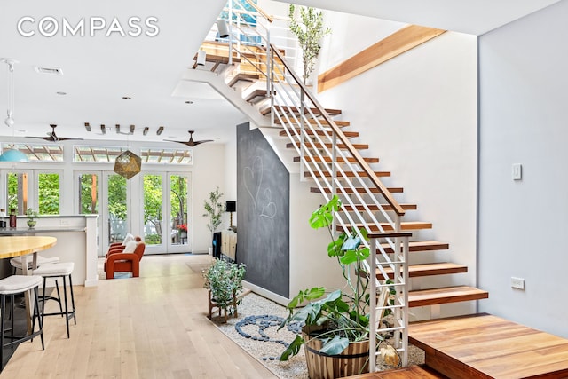 65 Jackson St, New York City, NY 11211 - staircase featuring a ceiling fan, french doors, and hardwood / wood-style floors