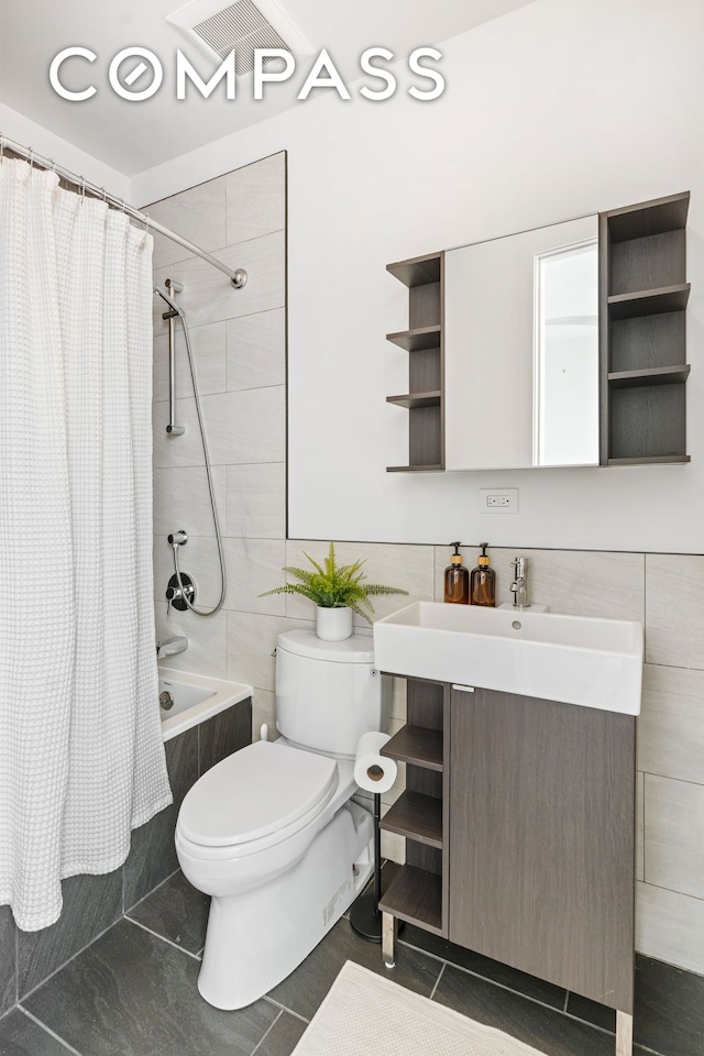 65 Jackson St, New York City, NY 11211 - full bath featuring shower / tub combo with curtain, vanity, tile walls, and tile patterned flooring