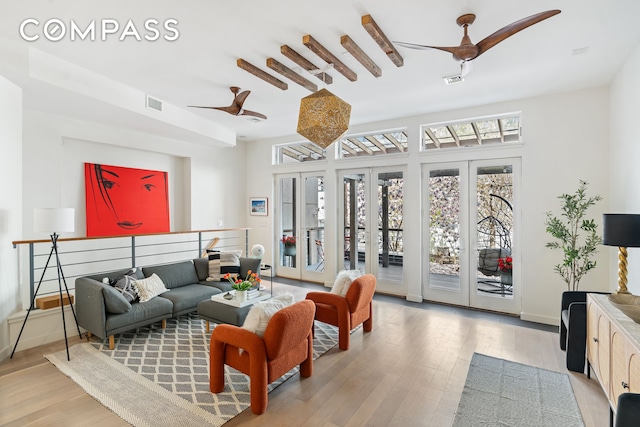 65 Jackson St, New York City, NY 11211 - living room with light wood-type flooring, french doors, and a ceiling fan
