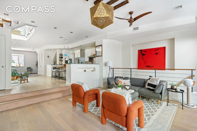 65 Jackson St, New York City, NY 11211 - living area featuring a skylight, light wood-style floors, and a ceiling fan
