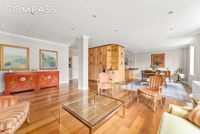 112 E 83rd St Unit 6C, New York City, NY 10028 - living area with crown molding, light wood-style floors, baseboards, decorative columns, and recessed lighting