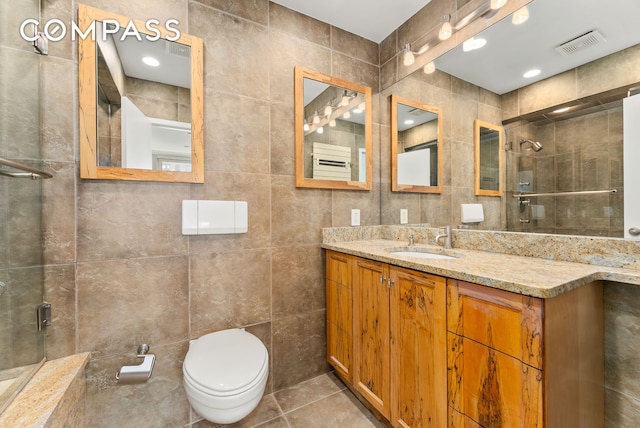 112 E 83rd St Unit 6C, New York City, NY 10028 - full bath featuring tile walls, a tile shower, vanity, tile patterned flooring, and toilet