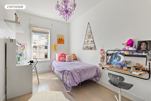 152 Senator St, New York City, NY 11220 - bedroom featuring light wood-type flooring, baseboards, and a chandelier