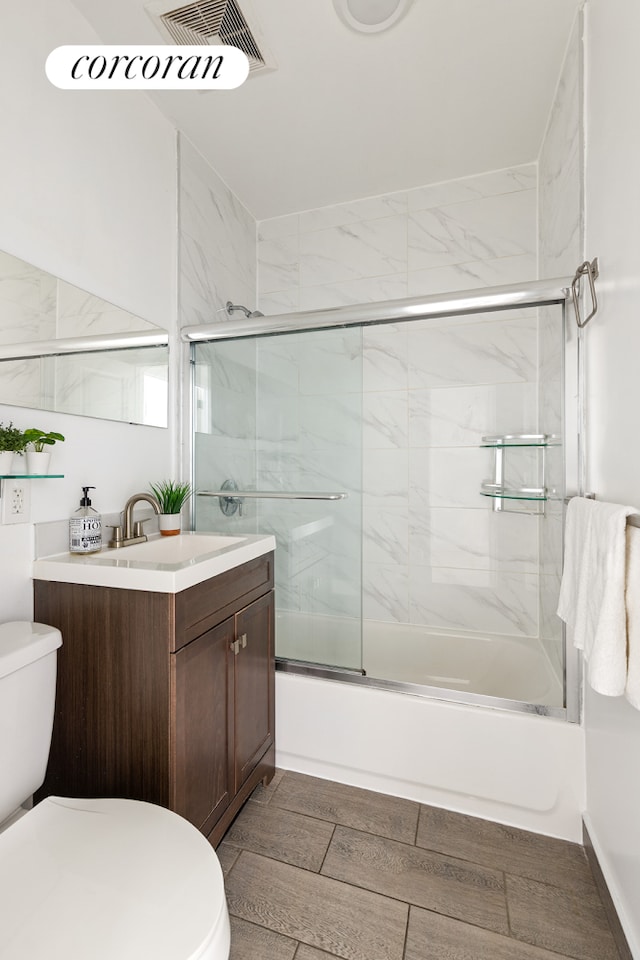 152 Senator St, New York City, NY 11220 - bathroom featuring toilet, vanity, and shower / bath combination with glass door