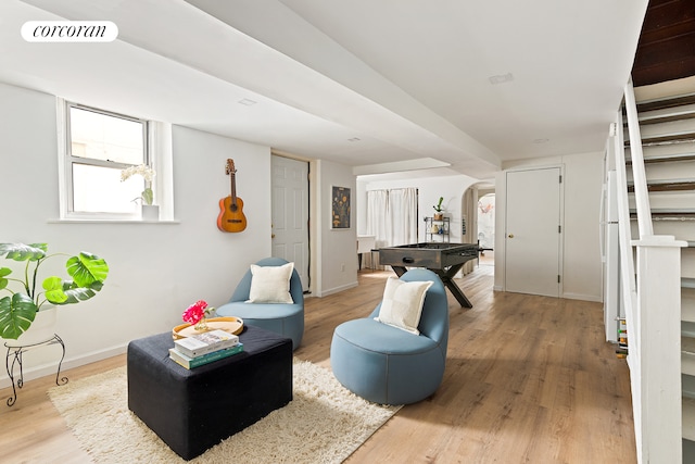 152 Senator St, New York City, NY 11220 - living area with arched walkways, wood finished floors, stairway, and baseboards