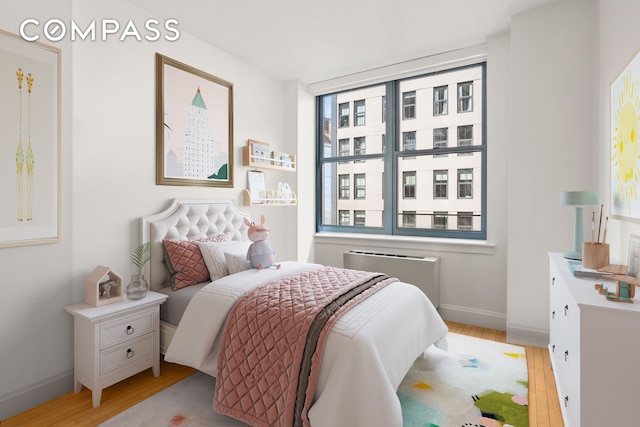 199 State St Unit 4C, New York City, NY 11201 - bedroom featuring wood finished floors, baseboards, and radiator heating unit