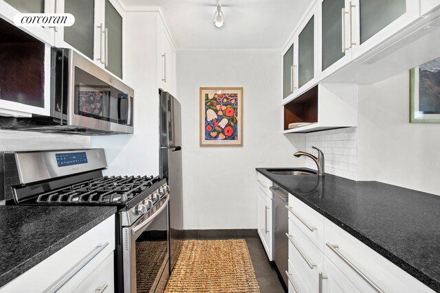 96 Schermerhorn St Phc, Phc, New York City, NY 11201 - kitchen featuring appliances with stainless steel finishes, a sink, decorative backsplash, white cabinetry, and dark tile patterned flooring