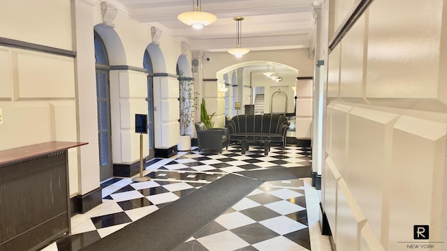 corridor featuring arched walkways and tile patterned floors