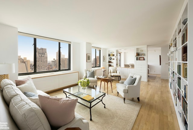 living area with a city view and light wood finished floors