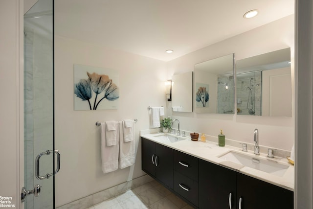 full bath with a sink, a shower stall, double vanity, and marble finish floor