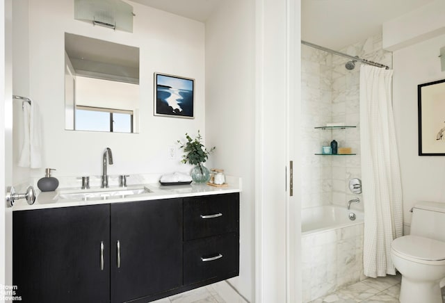 full bathroom featuring tiled shower / bath combo, toilet, marble finish floor, and vanity