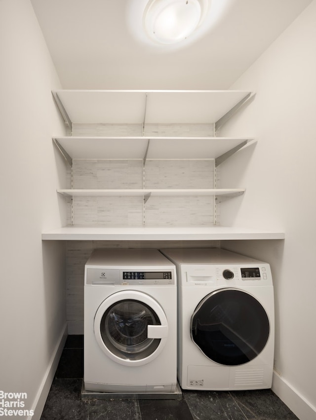 laundry room with separate washer and dryer, laundry area, and baseboards