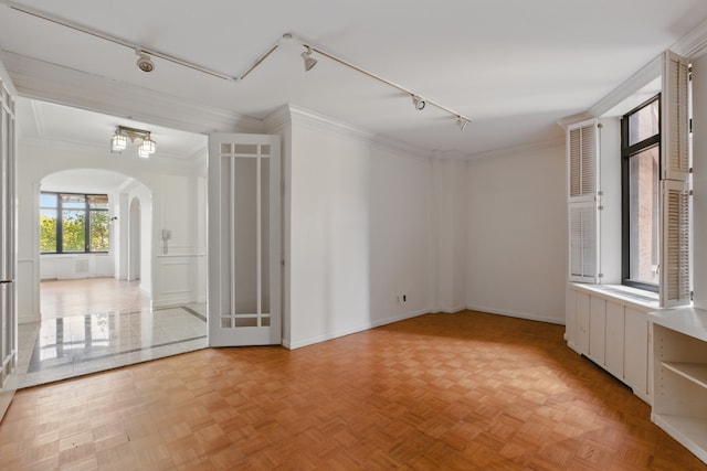 222 Riverside Dr Unit 5A, New York City, NY 10025 - spare room with arched walkways, rail lighting, ornamental molding, and baseboards