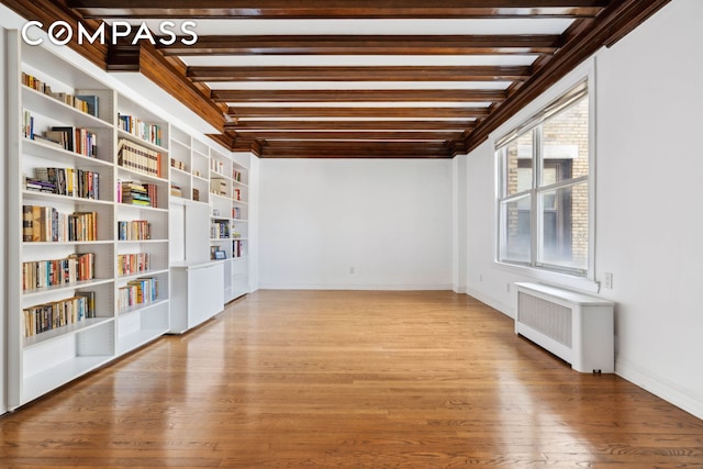 380 Riverside Dr Unit 7B, New York City, NY 10025 - spare room with radiator heating unit, baseboards, wood finished floors, built in shelves, and beam ceiling