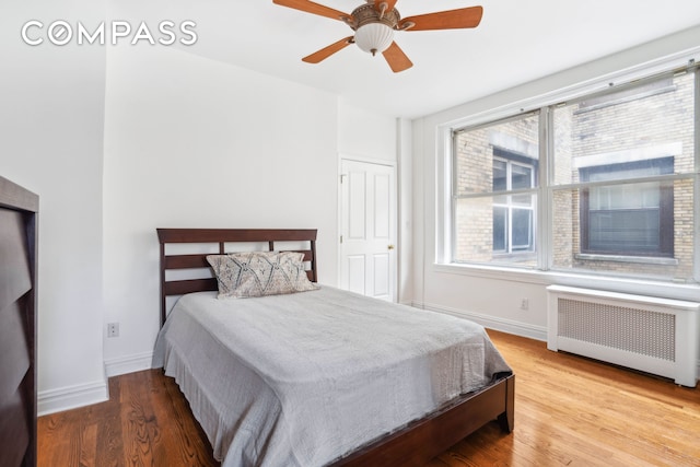 380 Riverside Dr Unit 7B, New York City, NY 10025 - bedroom featuring radiator heating unit, baseboards, wood finished floors, and a ceiling fan
