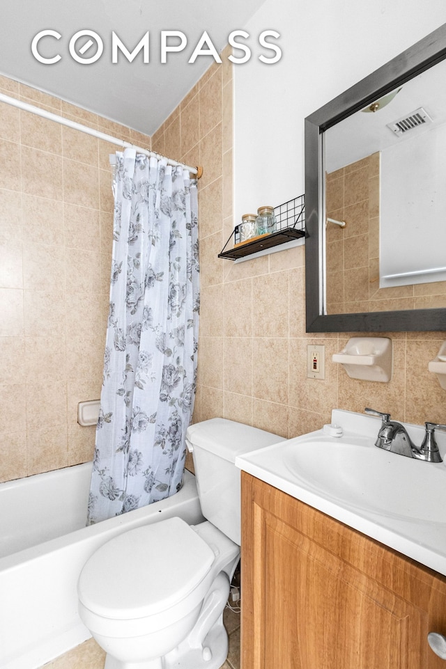 103A Patchen Ave, New York City, NY 11221 - bathroom with tile walls, shower / bath combo, toilet, vanity, and tasteful backsplash