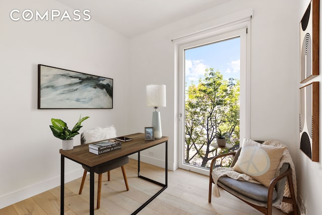 entryway with baseboards and light wood finished floors