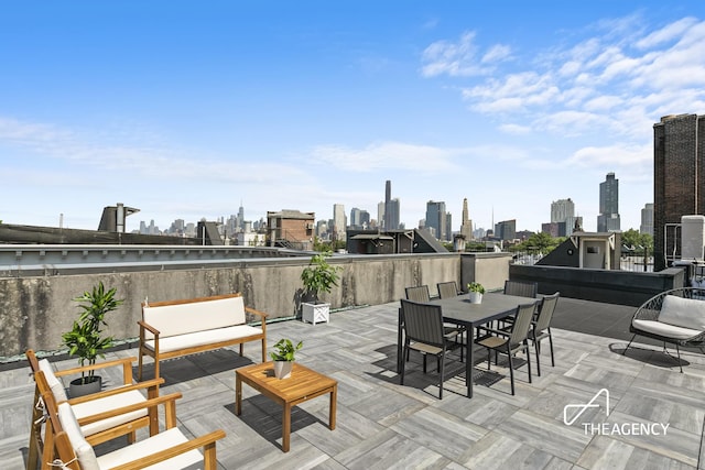 view of patio with a city view and outdoor dining space