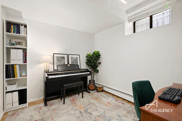 office featuring wood finished floors and a baseboard radiator