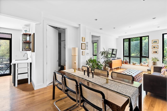 living area with recessed lighting and light wood-style flooring