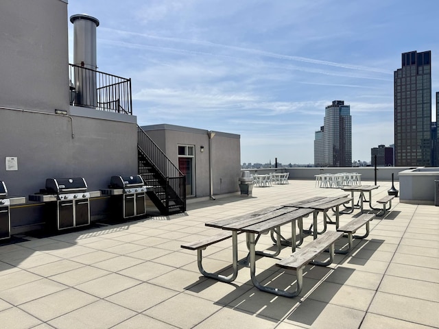 2-26 50th Ave Unit 7-F, New York City, NY 11101 - view of patio with area for grilling, stairway, and a view of city