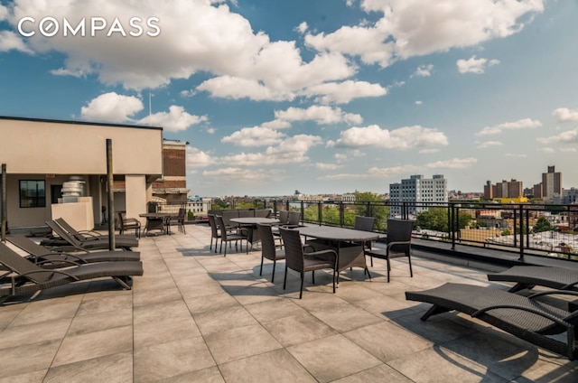 view of patio / terrace with outdoor dining area and a city view