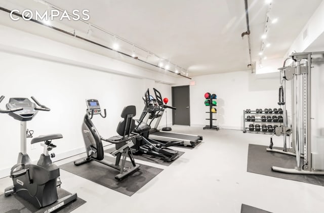 workout area featuring rail lighting and visible vents