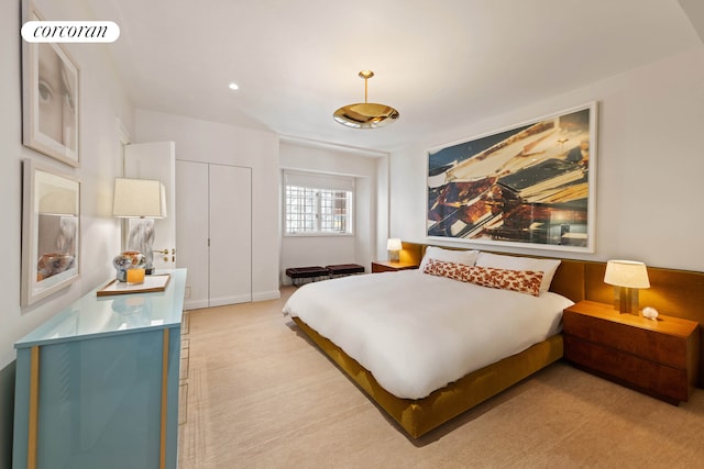 bedroom with light colored carpet and a closet