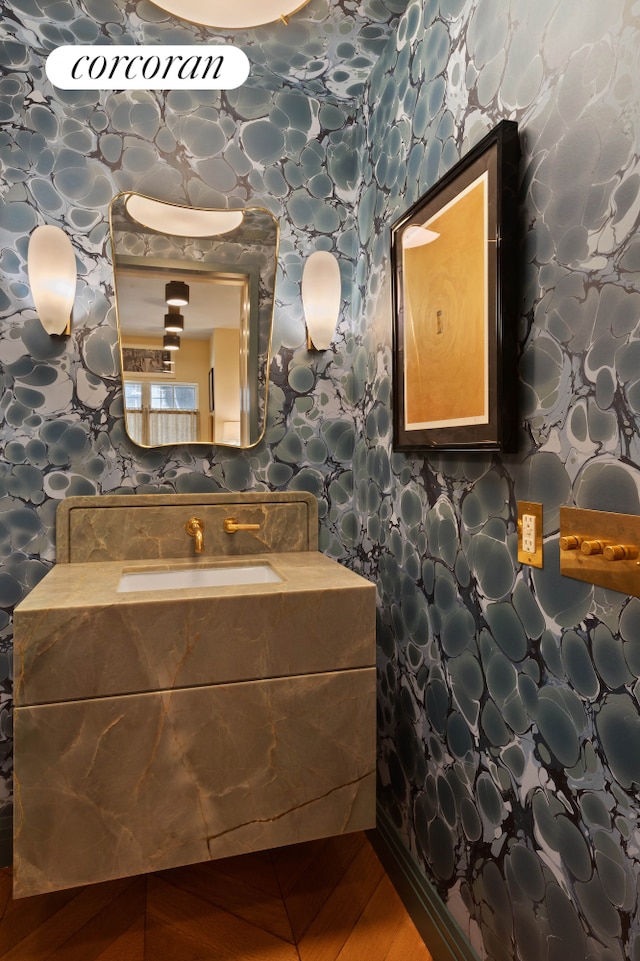 bathroom featuring wallpapered walls and vanity