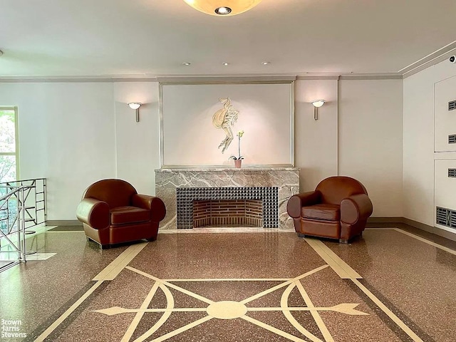 interior space featuring baseboards, ornamental molding, speckled floor, and a fireplace