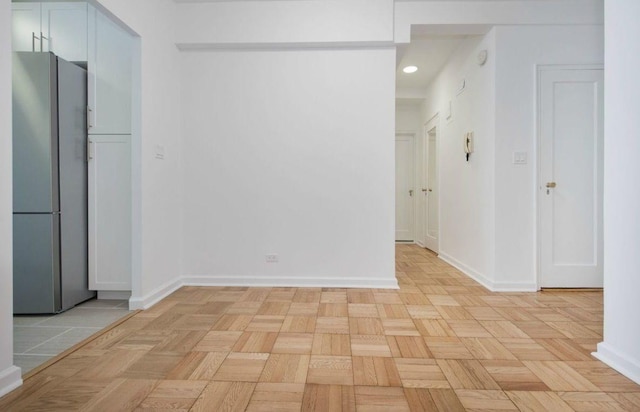 interior space with baseboards and recessed lighting