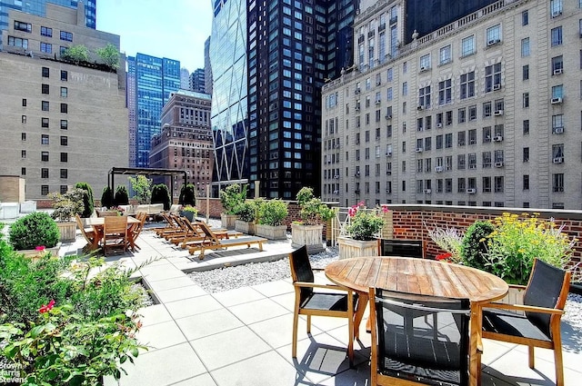 view of patio featuring a city view and outdoor dining space