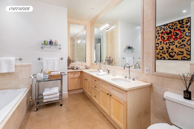 bathroom featuring toilet, tiled bath, a sink, and tile patterned flooring