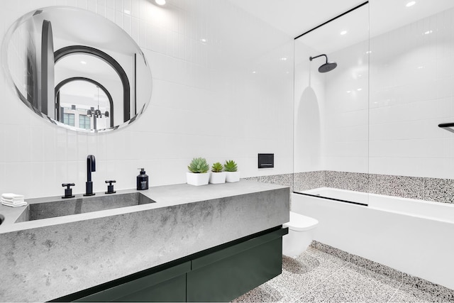 full bath featuring toilet, vanity, tile walls, and shower / bath combination