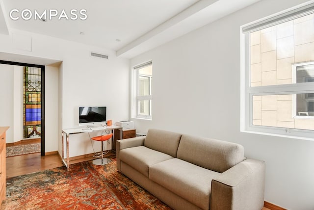 living room with wood finished floors and baseboards