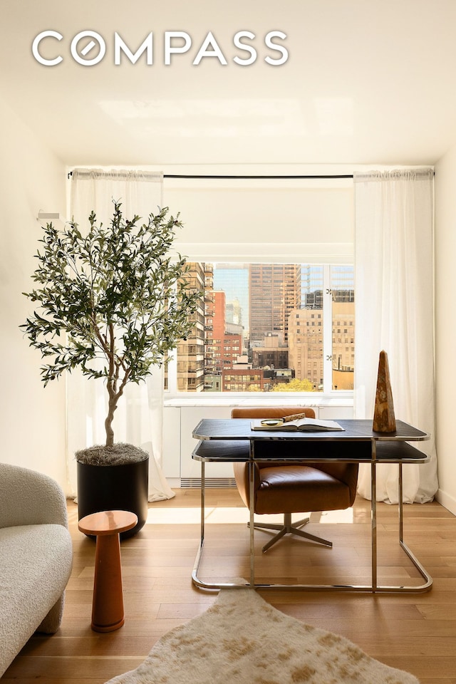166 E 63rd St Unit 11Bc, New York City, NY 10065 - living area featuring wood finished floors and a view of city