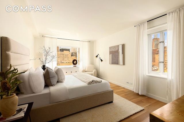 166 E 63rd St Unit 11Bc, New York City, NY 10065 - bedroom with light wood-type flooring and baseboards