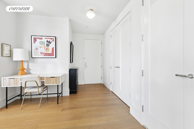 corridor with light wood-style floors and visible vents