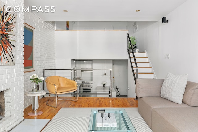 living area with stairs, recessed lighting, and wood finished floors