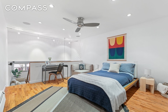 bedroom featuring recessed lighting, ceiling fan, a baseboard heating unit, and wood finished floors