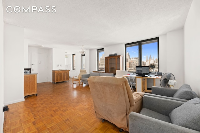 living room with a textured ceiling and baseboards