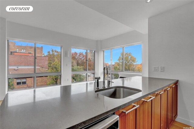 3585 Greystone Ave Unit 4C, New York City, NY 10463 - kitchen featuring a sink, brown cabinets, plenty of natural light, and recessed lighting