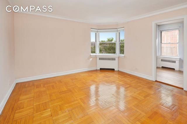 unfurnished room featuring radiator heating unit, baseboards, and crown molding