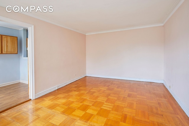 spare room with baseboards and ornamental molding