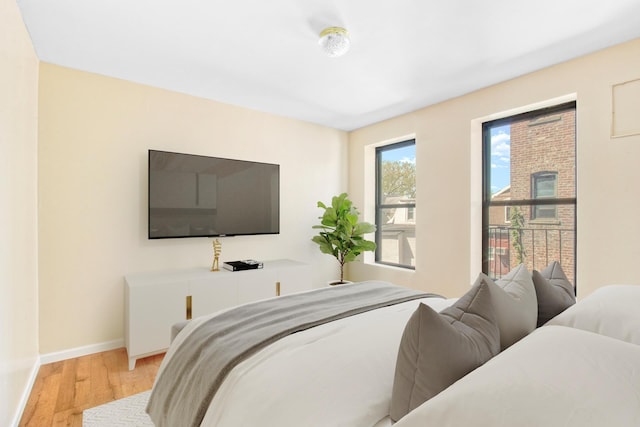 bedroom with baseboards and wood finished floors