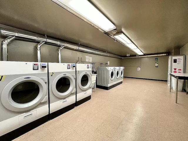 shared laundry area with tile patterned floors and washing machine and clothes dryer