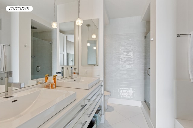 201 E 80th St Unit 23A, New York City, NY 10028 - full bath featuring a shower stall, tile patterned floors, toilet, and double vanity